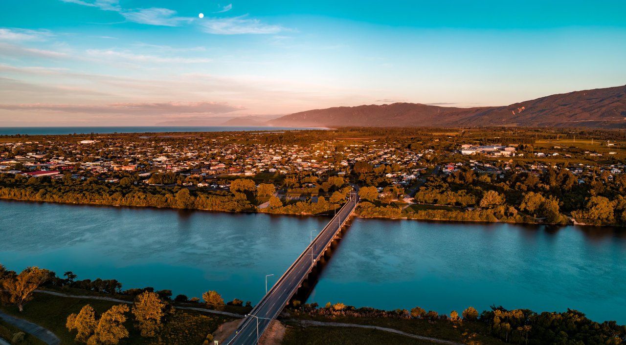 Aerial view of the Buller River bridge and Westport at sunset.