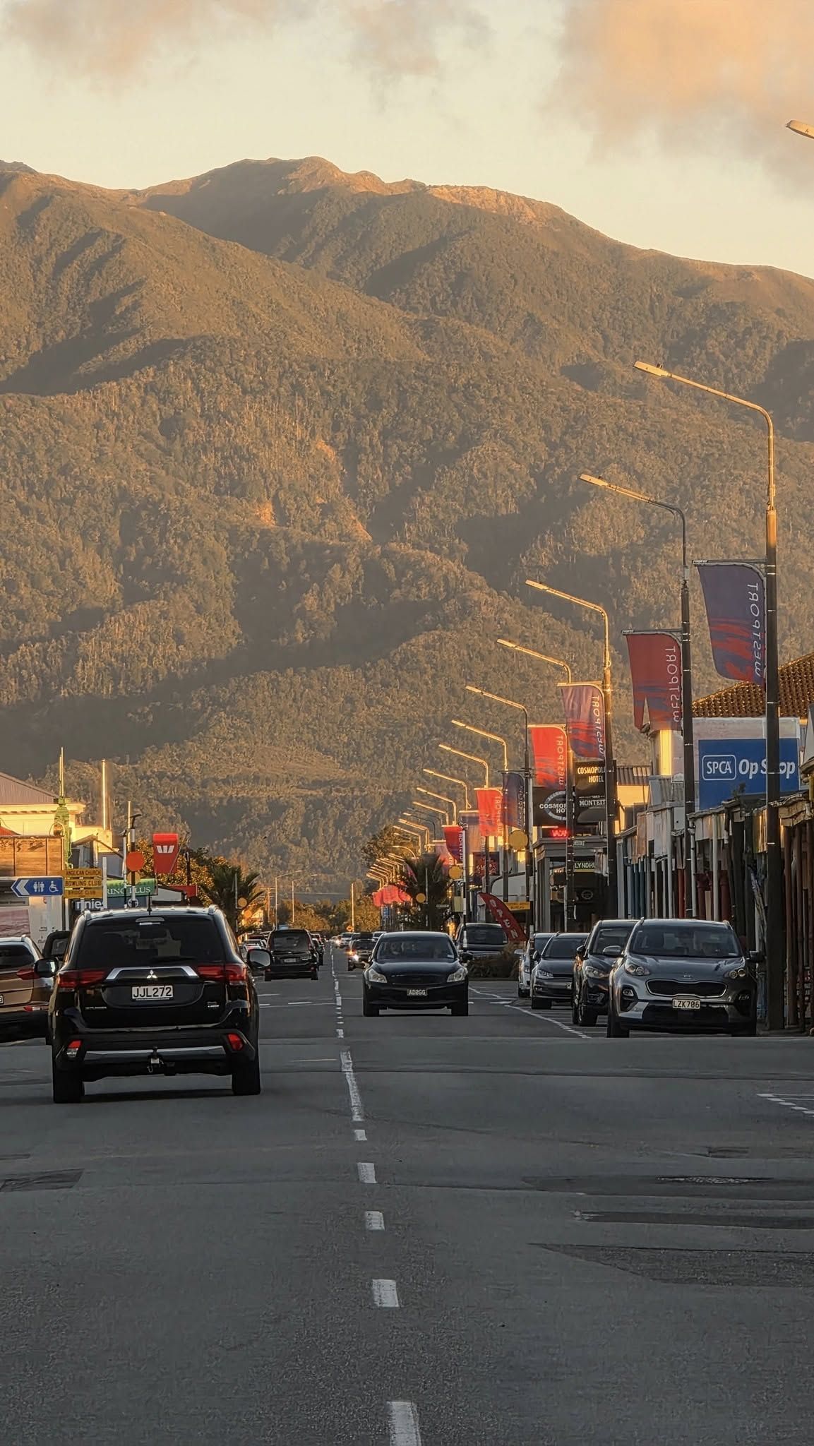 Palmerston Street, Westport, at sunset with the ranges behind.